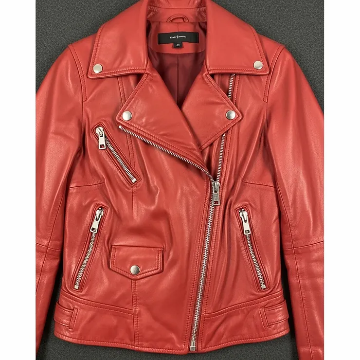 Front view of a women's red biker jacket with zippers and a snap-button collar, highlighting the asymmetrical design.