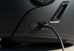 A clear shot of the charging port area on the Bluetooth motorcycle helmet, often discreetly located, to emphasize the long-lasting battery.