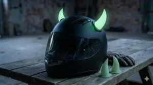 Luminescent green devil horn helmet accessories glowing in a dark setting.