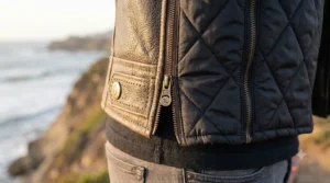 A cruiser motorcycle leather jacket with its quilted thermal liner partially unzipped, demonstrating multi-season warmth adaptability.
