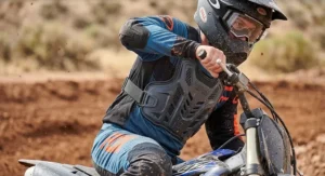 Motocross rider wearing a low-profile under-jersey motorcycle chest protector during an off-road ride
