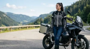 A female rider wearing a form-fitting mesh motorcycle jacket with reflective safety piping.