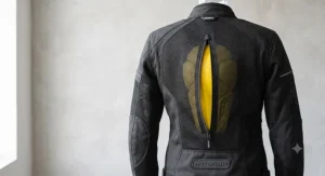 Rear view of a women's summer motorcycle jacket showing large mesh exhaust panels and a built-in back protector pocket.