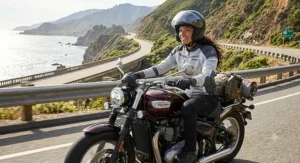 A female motorcyclist wearing a gray and white women's ventilated motorcycle jacket during a summer road trip.