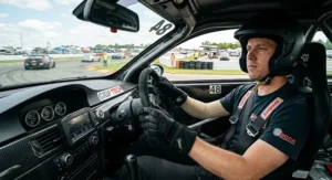 Driver wearing black track day gloves under 100 dollars during an HPDE event