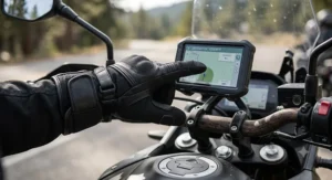 Motorcyclist using touchscreen-compatible touring gloves to adjust a GPS device on an adventure touring motorcycle.