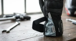 Close-up of a touring glove with a Gore-Tex waterproof membrane designed for weather protection on long highway rides.
