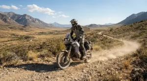 A rider standing on footpegs during dual-sport riding wearing adventure touring boots vs street touring boots
