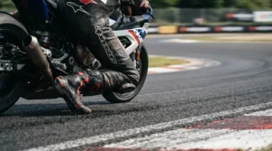 Close-up of racing boots for short riders showing proper clearance while leaning through a sharp curve.