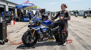 Rider standing near tire warmers wearing sport riding boots for hot weather track days on the grid