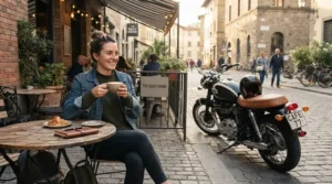 A rider sitting at an outdoor cafe bench showcasing casual commuter motorcycle shoes.