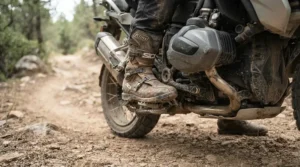 New enduro boots for beginner off-road riders being tested on a dusty dirt track.