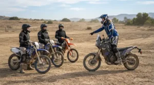 Students learning proper stance wearing enduro boots for beginner off-road riders at a dirt bike school.