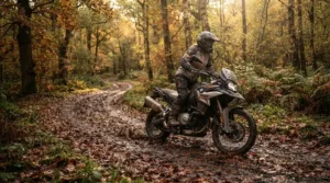 Cruising down a damp autumn trail wearing high-performance waterproof adventure boots for mud.
