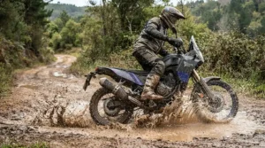 Adventure rider splashing through muddy puddles wearing waterproof women's motorcycle boots for rain.